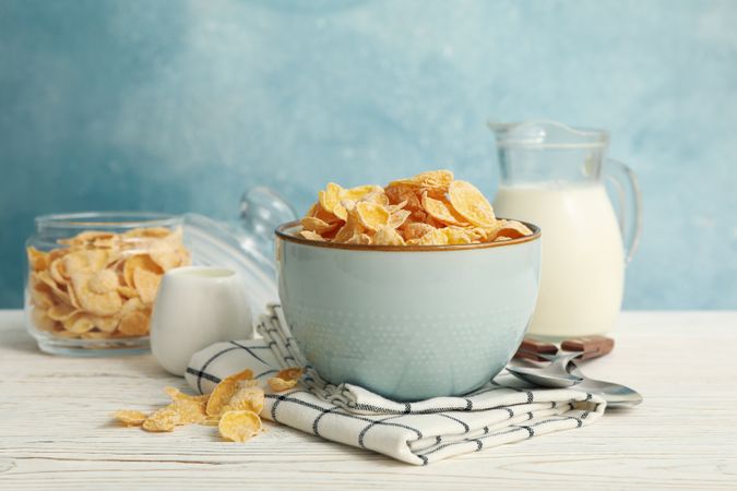 Concept of breakfast with muesli and milk on wooden table