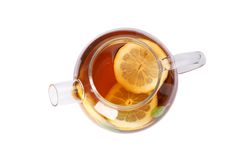 Glass teapot with lemon slices isolated on blank background