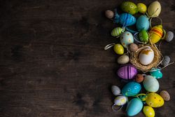 Top view of Easter card concept with colorful eggs on table