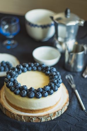 Cheesecake decorated with blueberries on table