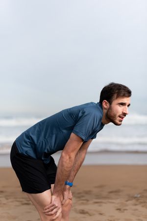 Sportsman resting on beach