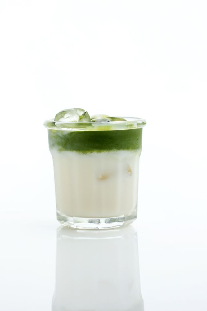 Glass of Tasty Matcha Latte isolated on Studio Background
