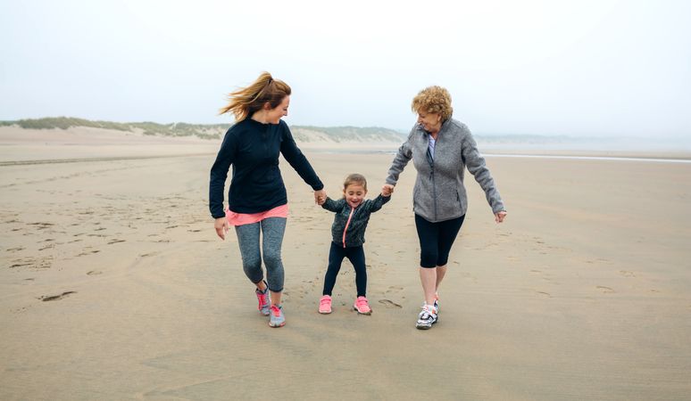 Three generations running on the beach