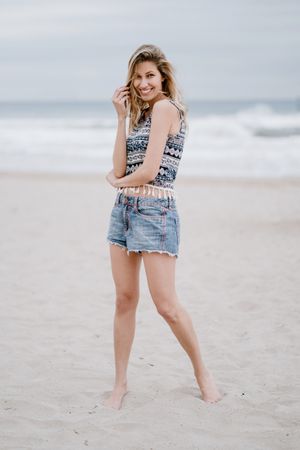 Happy female laughing on sandy beach