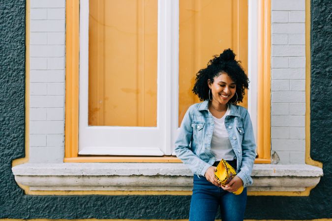 Smiling female by yellow window