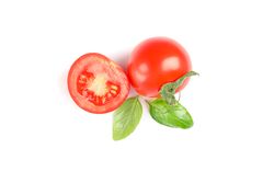 Fresh cherry tomatoes with basil isolated on blank background, top view. Ripe vegetables