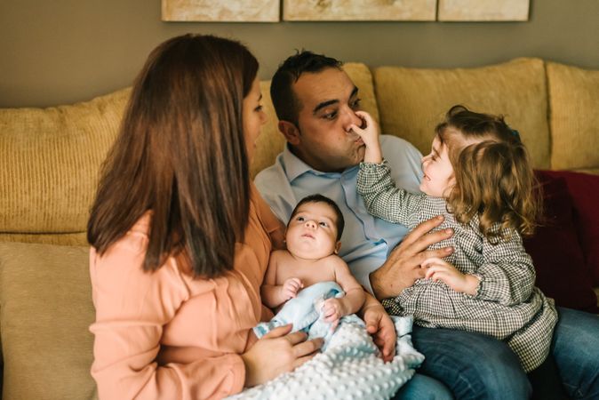 Happy family sitting on couch together
