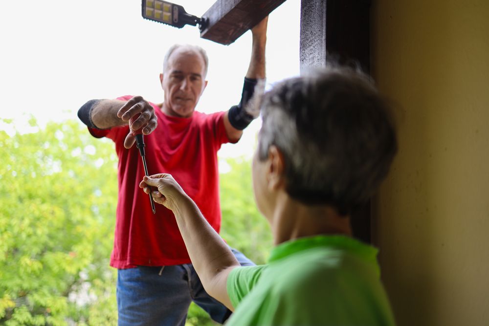 Older woman helping her husband on home improvement.