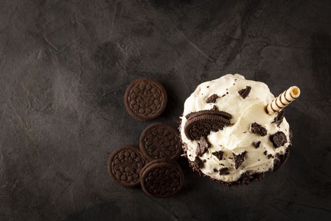Chocolate milkshake with pieces of chocolate chip cookies.