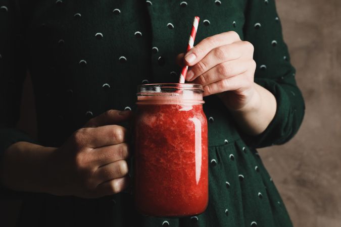 Woman hold glass jar of strawberry cocktail, close up. Summer drink