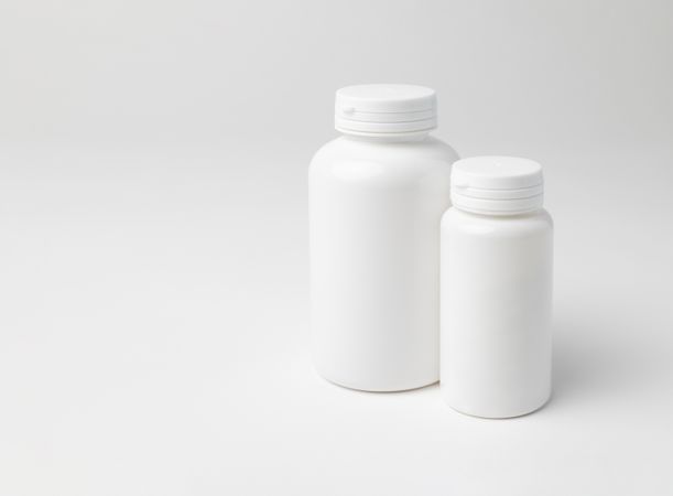 Mockup of two closed plastic medicine bottles, with copyspace, perfect for design mockups