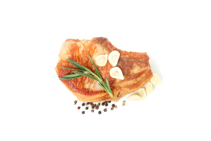 Fried pork steak isolated on light background. Grilled food