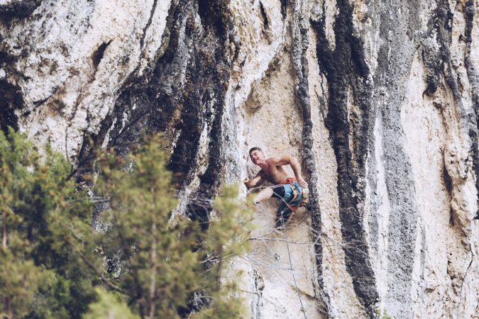 Anonymous man climbing rock