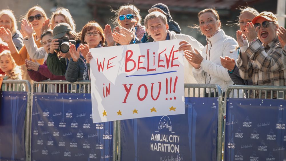 Marathon Supporters Waving at Their Loved Ones During a Sprint.