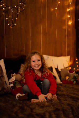 Little girl surrounded by christmas decoration