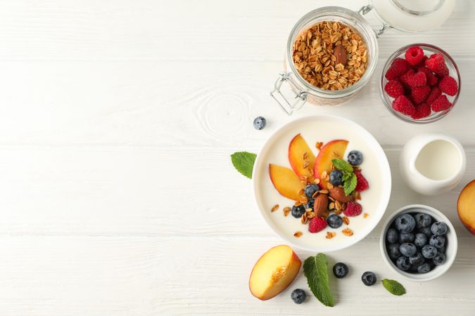 Flat lay composition with parfaits dessert and ingredients on wooden background