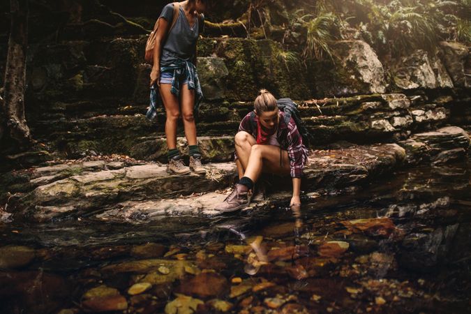 Two women hikers by a water pond