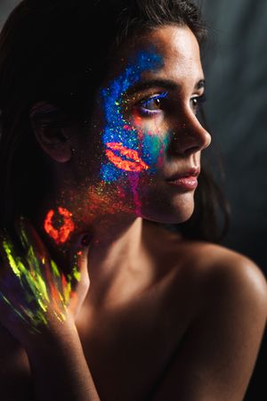Young woman covered with uv painting