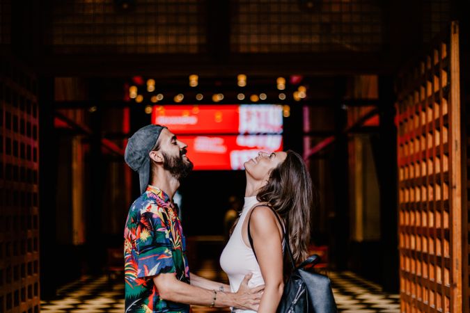Laughing couple against building entrance