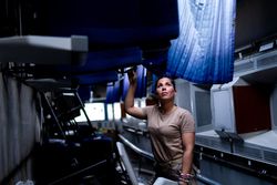Military woman looking up inside vehicle