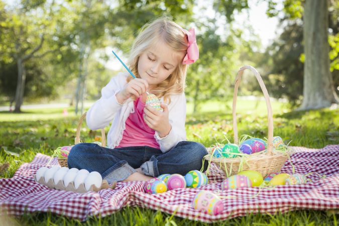 Cute Young Girl Coloring Her Easter Eggs with Paint Brush
