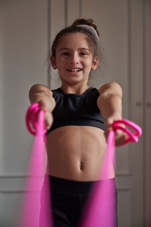 Happy girl with jumping rope at home
