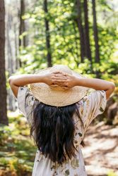 Woman enjoying a day in nature, walking through the forest