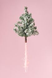 Christmas tree blasting off with fireworks emerging from base