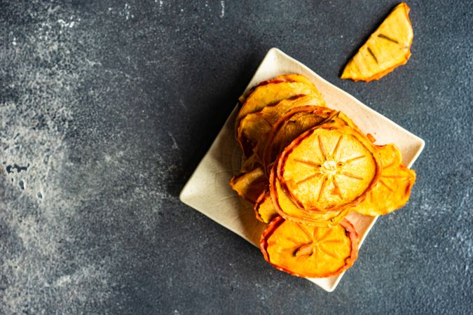 Top view of dried persimmon fruits piled on square plate