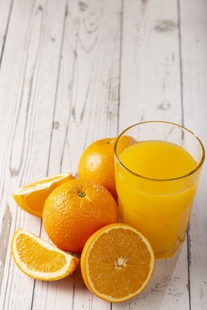 Glass with orange juice on the table.