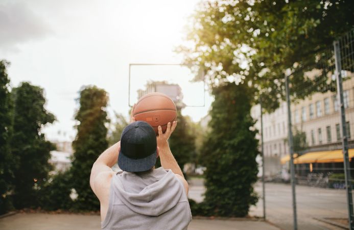 Streetball player shoots basket