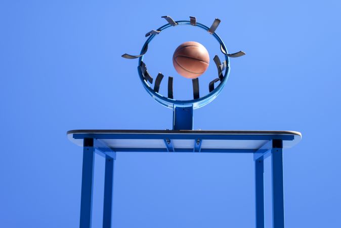 Image of a ball beside a basketball hoop