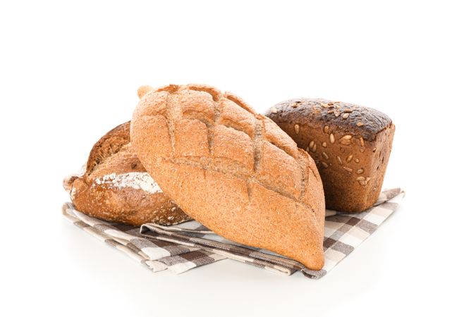 Bakery products on kitchen towel isolated on blank background