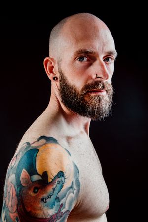 Young shirtless bearded guy with tattoos