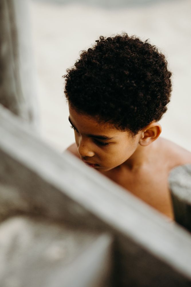 Black boy standing near steps