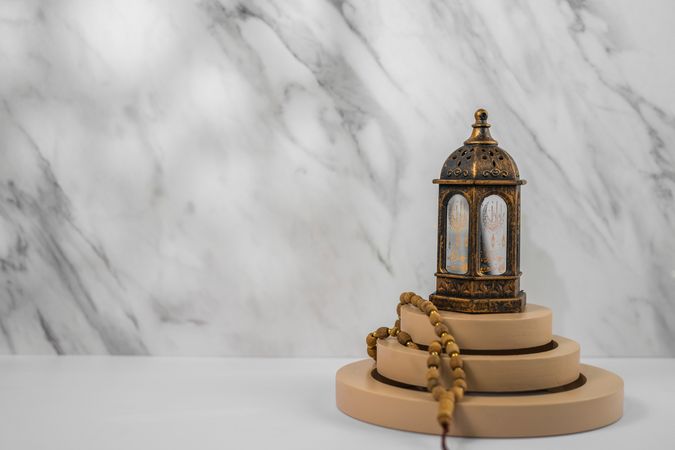 Decorative Lantern and Prayer Beads on Minimalist Circular Stands