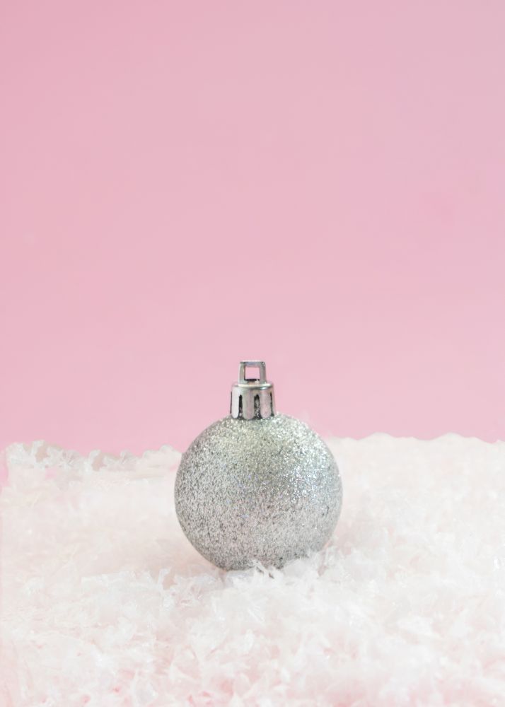 Silver Christmas decorations sitting in snow