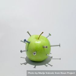 Green apple stabbed with many screws bEedAb