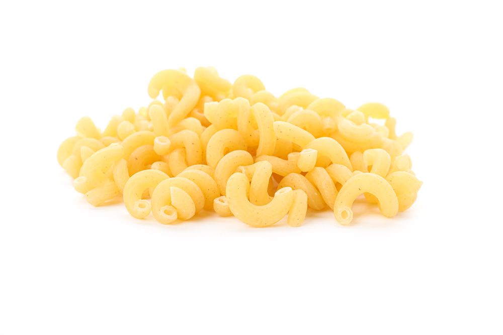 Pasta isolated on light background, closeup. Dry uncooked whole pasta