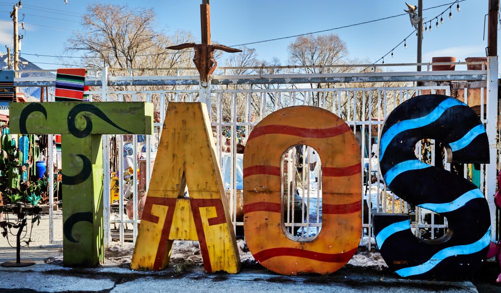 Sign for “Taos” at Camino Real Imports and Gift Shop in Taos, New Mexico