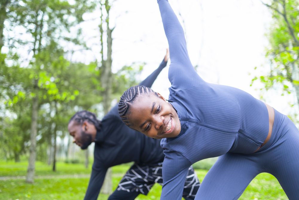 Two friends stretching before their training.