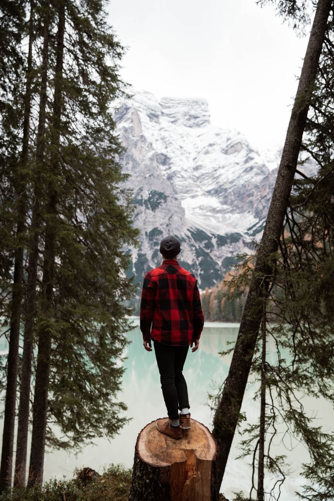 Man delighting in views near lake and mountains