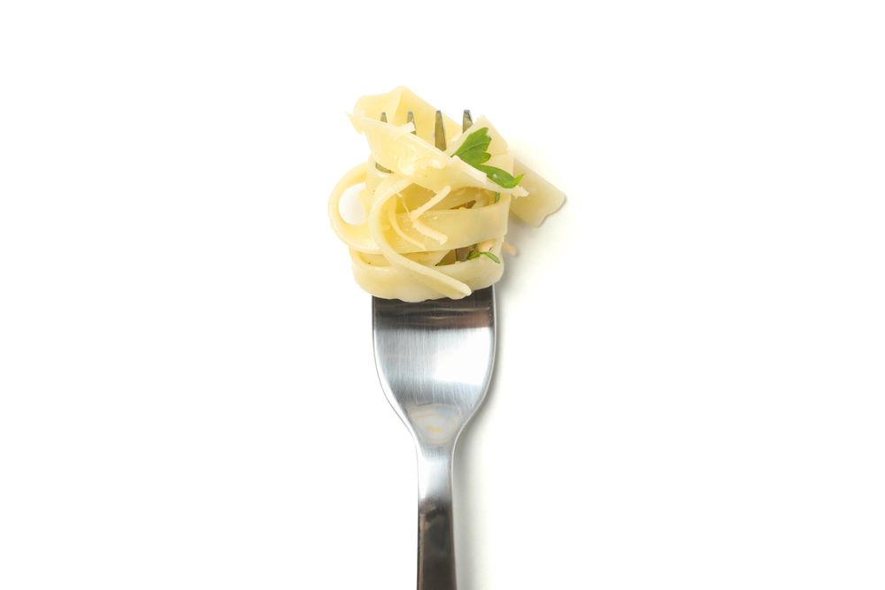Fork with tasty pasta isolated on studio background
