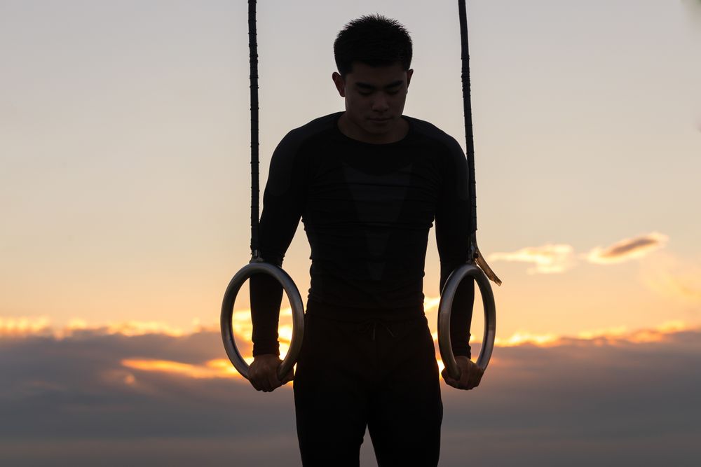 Sportsman training on gymnastic rings