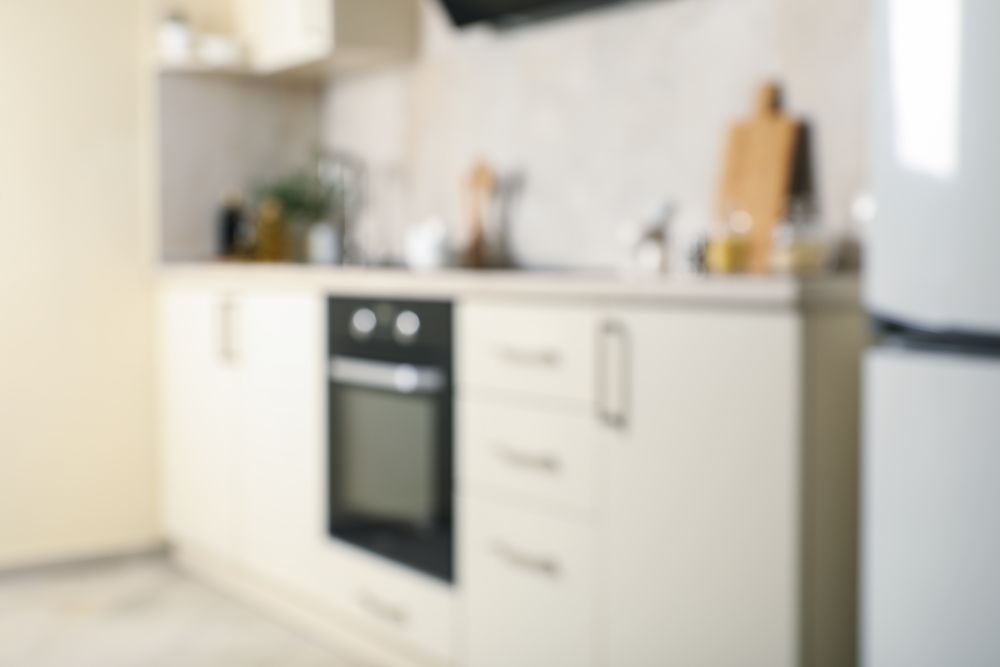 Modern kitchen interior with different supplies in light colors
