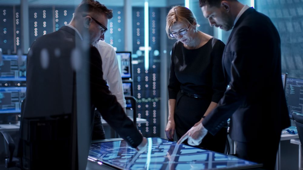 Government Agents Working at the Big Table in Monitoring Room.