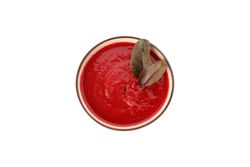 Top view of bowl of tomato soup in bright room