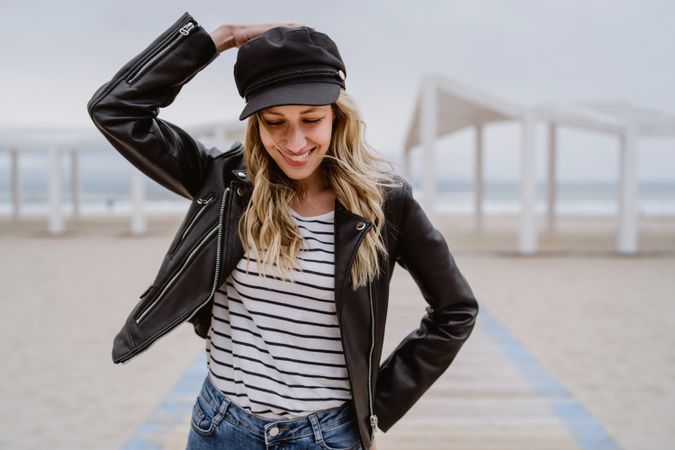 Woman on white wooden pier with ocean on background