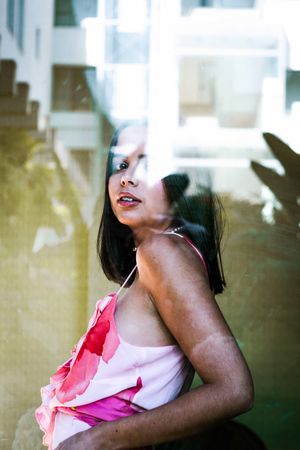 stylish woman looking through window