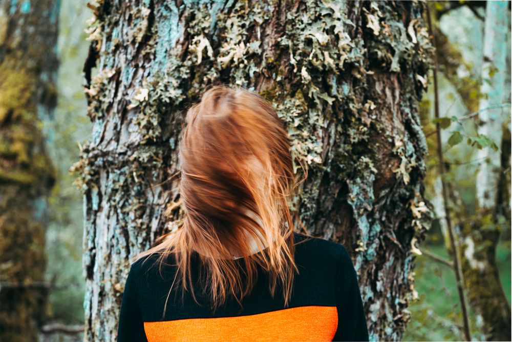 Casual redhead woman shaking with hair